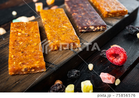 Dried fruits bars, on wooden table 75856576
