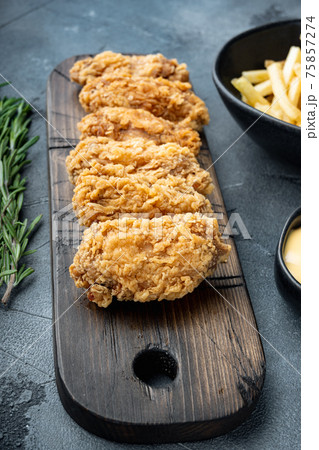 Spicy deep fried breaded chicken wings on grey background Spicy deep fried breaded chicken wings on grey background 75857274