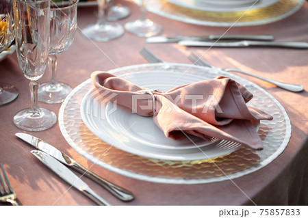 Decorated pink banquet table set with napkin 75857833