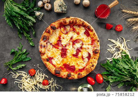 Baked pepperoni pizza on the decorated background Baked pepperoni pizza on the decorated background 75858212