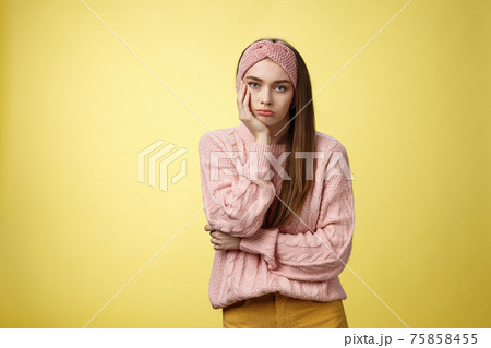 How boring. Indifferent upset gloomy girl missing party feeling bored leaning on palm reluctant, sad looking careless at camera visiting uninteresting lecture, suffering boredom over yellow wall 75858455