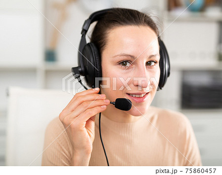 Happy call center operator talking with client 75860457