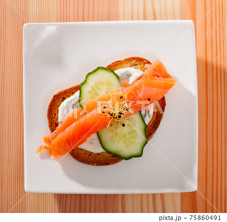 Sandwich with salmon, cucumber, sauce Sandwich with salmon, cucumber, sauce 75860491