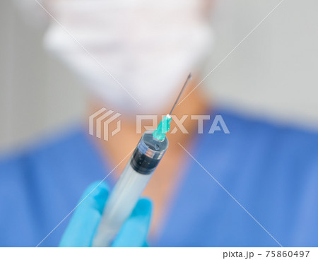 Nurse with vaccine. Nurse are showing syringe of vaccine 75860497