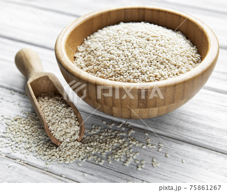 Sesame seeds in a bowl on a rustic table Sesame seeds in a bowl on a rustic table 75861267