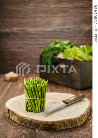 Fresh green beans on wooden cutting board Fresh green beans on wooden cutting board 75861486