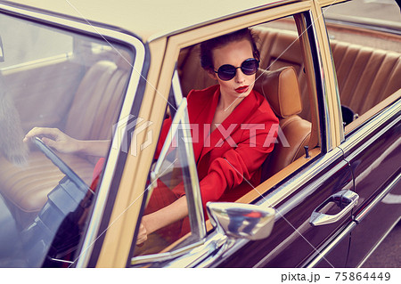 Beautiful young woman in retro car Beautiful young woman in retro car 75864449