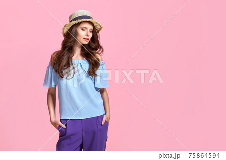 Young girl in colorful clothes wearing straw hat, isolated over pink background Young girl in colorful clothes wearing straw hat, isolated over pink background 75864594