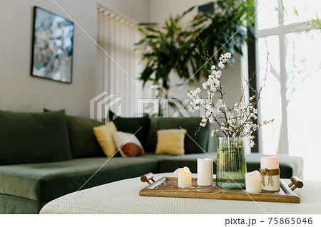 Home interior. Relaxing candles. Apple tree color has flown. Blurred background 75865046
