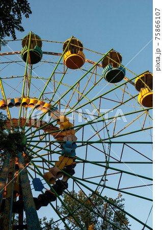 a colourful ferris wheel. front view. against the blue sky on a sunny day a colourful ferris wheel. front view. against the blue sky on a sunny day 75866107