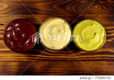 Set of sauces on wooden table 75866742