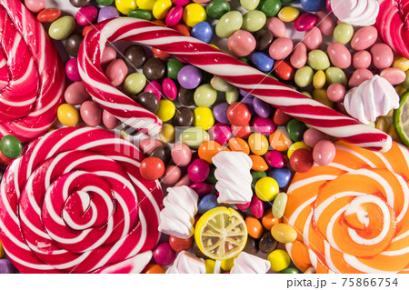 Background of colorful chocolate candies, lollipops, candy cane and marshmallows 75866754