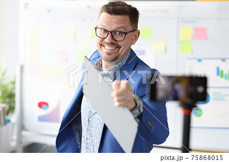 Business coach pointing to mobile phone camera 75868015