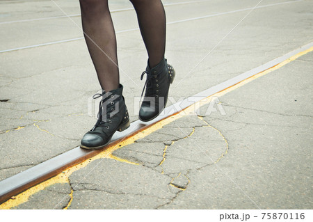 Girl walking on the tracks of the tram Girl walking on the tracks of the tram 75870116