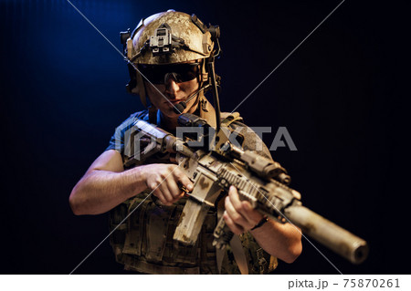 Special forces soldier with rifle on black background 75870261