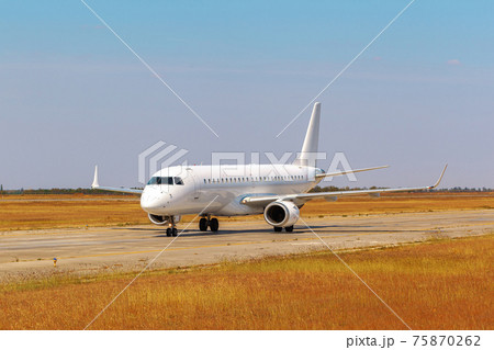 Big passenger airplane drives along the runway in airport 75870262