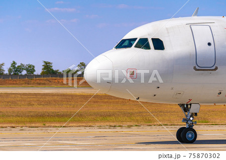 Cockpit of big passenger airliner on runway close up 75870302