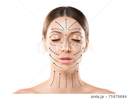 Beautiful caucasian female face with closed eyes and hair up in a bun. Skin marked with black arrows on the main facial lifting lines, front view, isolated on white. 75870684