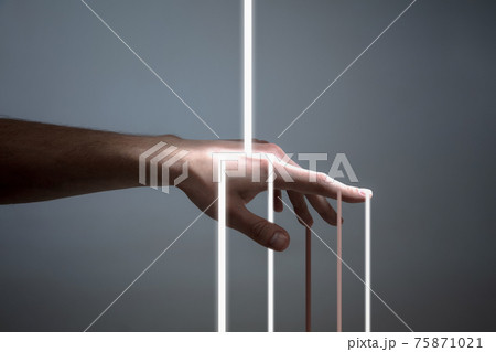 Light rays passing through delicate female hand isolated over grey background. Light rays passing through delicate female hand isolated over grey background. 75871021