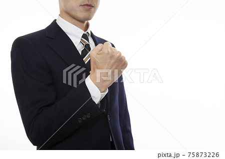 ガッツポーズをするスーツを着たビジネスパーソンの写真素材