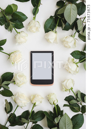 floral composition with tablet, fresh white roses on white background. Flatlay, top view. Copy space mockup template. floral composition with tablet, fresh white roses on white background. Flatlay, top view. Copy space mockup template. 75873675