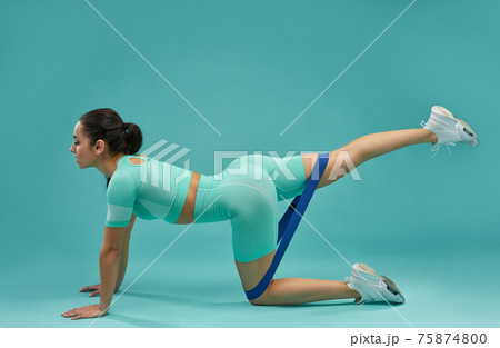 Sporty young woman working out with fitness band Sporty young woman working out with fitness band 75874800