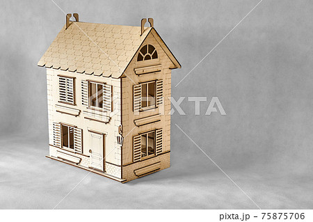 Laser cut doll house of plywood on grey Laser cut doll house of plywood on grey 75875706