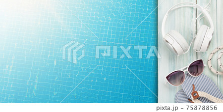 Pool and beach items, headphones and water surface of swimming pool Pool and beach items, headphones and water surface of swimming pool 75878856