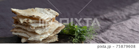 Homemade matzo with microgreen peas. Unleavened flatbread bread. Pesah celebration concept. Jewish Passover background. Pita. 75879608