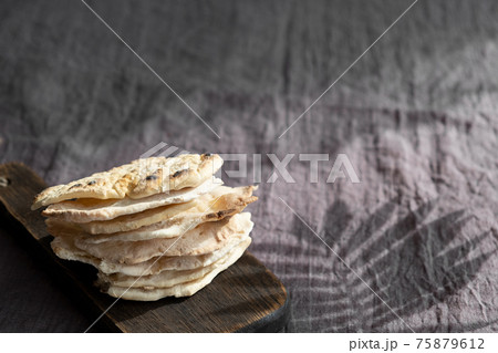 Homemade matzo with microgreen peas. Unleavened flatbread bread. Pesah celebration concept. Jewish Passover background. Pita. Homemade matzo with microgreen peas. Unleavened flatbread bread. Pesah celebration concept. Jewish Passover background. Pita. 75879612