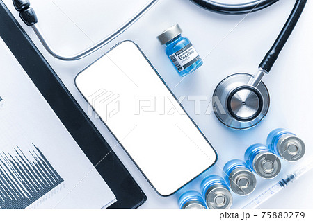 Medical application. Hospital equipment: doctor stethoscope, healthcare charts, syringe with needle and black smartphone with blank screen. Mockup generic device. Medical application. Hospital equipment: doctor stethoscope, healthcare charts, syringe with needle and black smartphone with blank screen. Mockup generic device. 75880279
