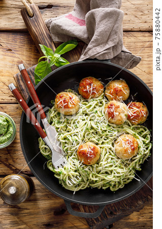Pasta with meatballs and pesto sauce 75880442