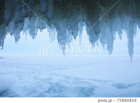View from icy grotto to the winter Baikal lake in February day View from icy grotto to the winter Baikal lake in February day 75880839