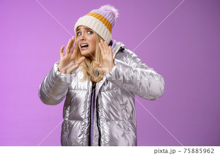 Afraid intense uncomfortable young fair-haired woman in winter hat silver stylish dress run away raise hands self-defense turn head away scared friend spill drink new outfit, purple background Afraid intense uncomfortable young fair-haired woman in winter hat silver stylish dress run away raise hands self-defense turn head away scared friend spill drink new outfit, purple background 75885962