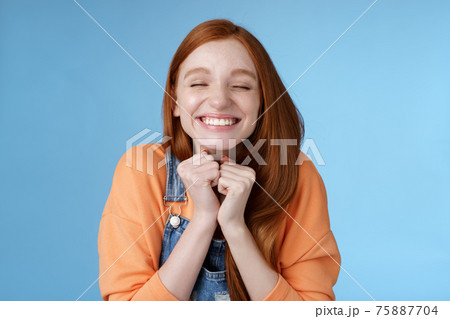 Eager rejoicing thrilled pretty young redhead girl close eyes dreamy smiling receive great result scholarchip triumphing joyfully grinning squeez hands excited, standing blue background very happy Eager rejoicing thrilled pretty young redhead girl close eyes dreamy smiling receive great result scholarchip triumphing joyfully grinning squeez hands excited, standing blue background very happy 75887704