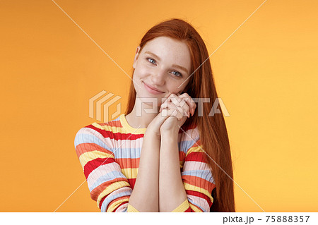 Dreamy sensual romantic young passionate redhead girlfriend melt heart feel sympathy joy receive sweet tender present lean palms smiling grateful gladly accept nice lovely gift, orange background Dreamy sensual romantic young passionate redhead girlfriend melt heart feel sympathy joy receive sweet tender present lean palms smiling grateful gladly accept nice lovely gift, orange background 75888357