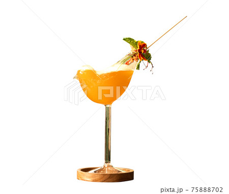 Orange juice in a bird-shaped glass on white background. Orange juice in a bird-shaped glass on white background. 75888702