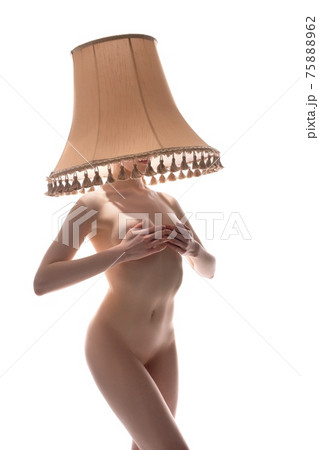 Naked woman with lampshade on head covering breast 75888962