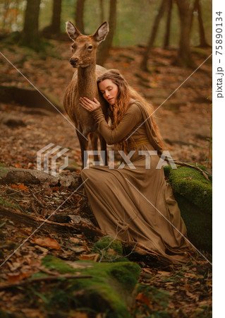 Redhead girl with deer in a long dress Redhead girl with deer in a long dress 75890134