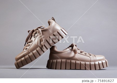 beige sneakers. fashion shoes still life 75891627