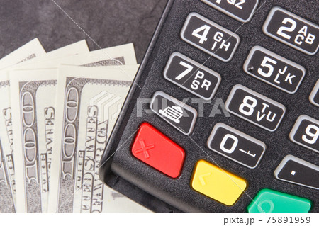 Payment terminal, credit card reader and money. Cashless or cash paying for shopping 75891959
