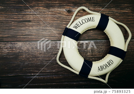 Lifebuoy Marine Decoration with space copy on wooden background Lifebuoy Marine Decoration with space copy on wooden background 75893325