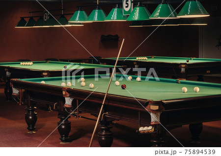 Billiard table with green surface and balls in the billiard club.Pool Game Billiard table with green surface and balls in the billiard club.Pool Game 75894539
