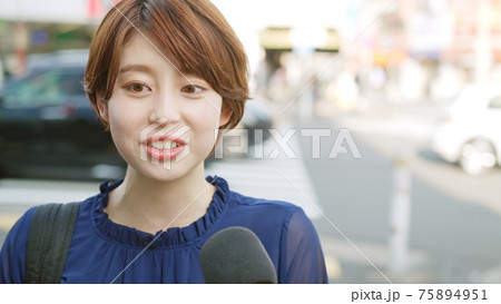 街頭インタビューを受ける女性 75894951