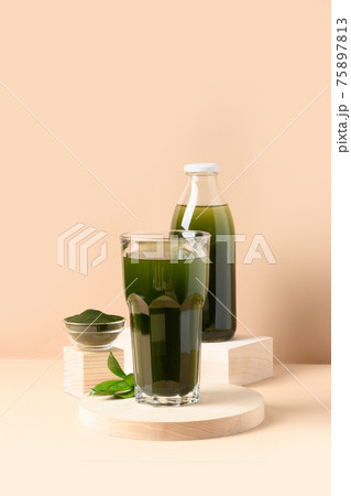 Chlorella Detox drink in glass on beige. Chlorella Detox drink in glass on beige. 75897813