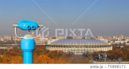 Touristic telescope viewer (binoculars) and Panoramic view of Sparrow Hills or Vorobyovy Gory observation (viewing) platform-- is on a steep bank 85 m above the Moskva river, or 200 m above sea level. Touristic telescope viewer (binoculars) and Panoramic view of Sparrow Hills or Vorobyovy Gory observation (viewing) platform-- is on a steep bank 85 m above the Moskva river, or 200 m above sea level. 75898171
