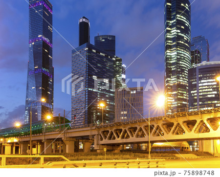 Moscow Central Circle (Little Ring, MCC,or MK MZD) and skyscrapers of the International Business Center (City) at night, Russia. Delovoy Tsentr railway station Moscow Central Circle (Little Ring, MCC,or MK MZD) and skyscrapers of the International Business Center (City) at night, Russia. Delovoy Tsentr railway station 75898748