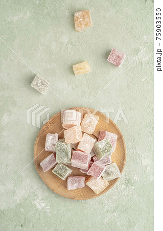 colorful Turkish delights on the plate on green 75903550