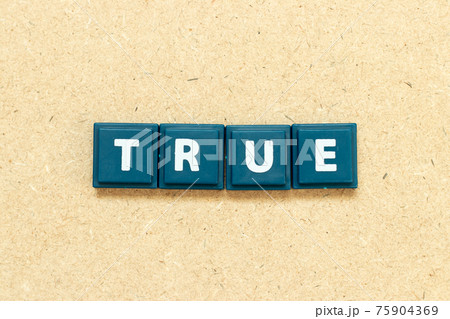 Tile alphabet letter in word true on wood background 75904369