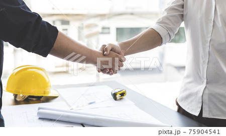 Men shake hands after the deal is done, Architects and engineers join hands to congratulate them after the building site meeting is completed, Symbol of friendship in business of both parties. Men shake hands after the deal is done, Architects and engineers join hands to congratulate them after the building site meeting is completed, Symbol of friendship in business of both parties. 75904541
